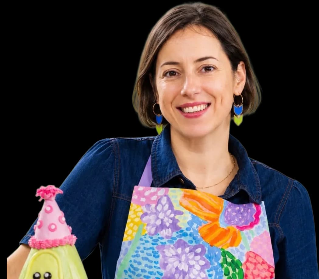 Pam smiling in her kitchen, wearing a floral apron