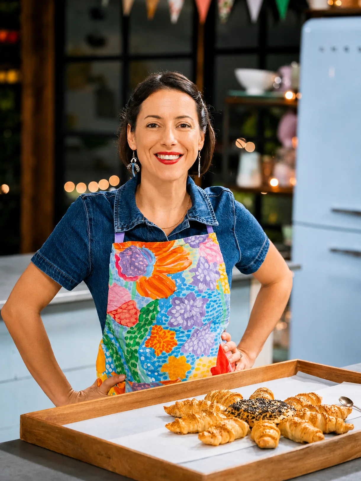 Pam smiling behind a tray of freshly baked croissants